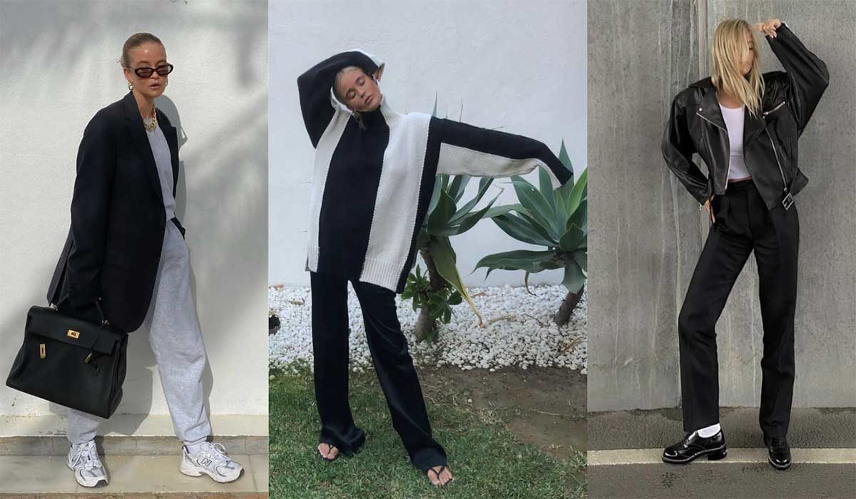 elegancka blondynka w beżowym płaszczu i szarych spodniach stoi przy drzewie